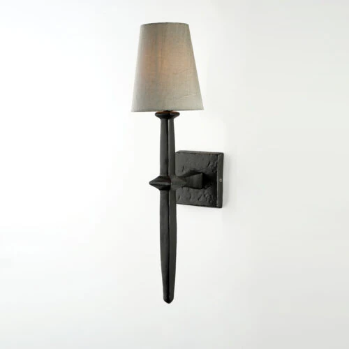 The ADAM WALL SCONCE features a black metal design with a textured square base, slim vertical body, and a light gray fabric lampshade, shown against a plain white background.