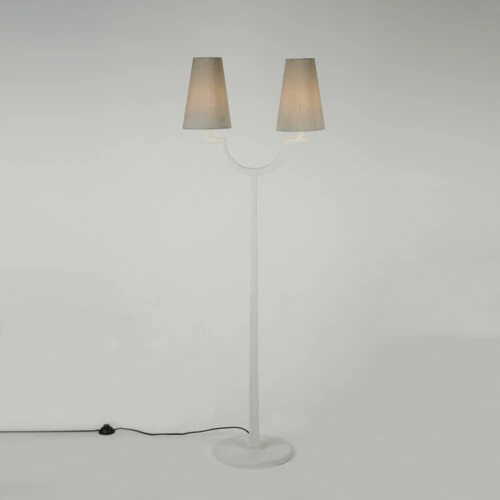 The MYKONOS FLOOR LAMP is a modern white floor lamp with two gray lampshades, a round base, and a black power cord with switch, shown against a plain light background.