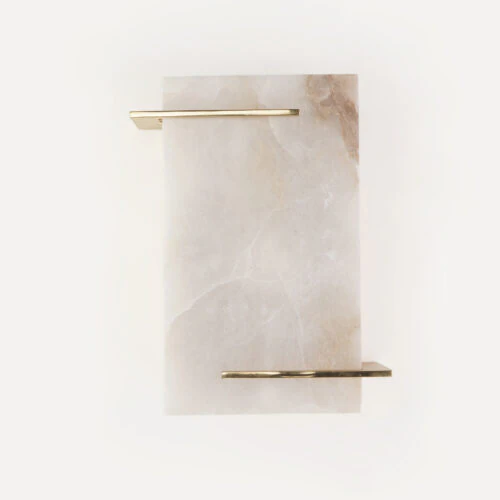 The SOHO WALL SCONCE features a rectangular white marble slab with subtle brown veins and two parallel gold metal bars affixed near the top left and bottom right, set against a plain white background.